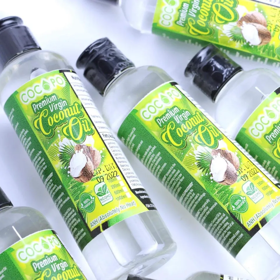 Cocopo premium virgin coconut oil in clear bottles with black flip-top caps