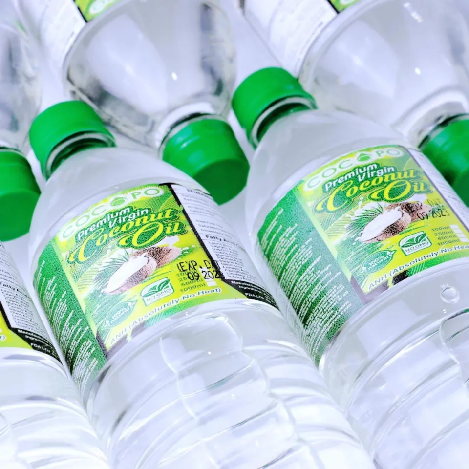 Cocopo premium virgin coconut oil in round bottles with green screw caps